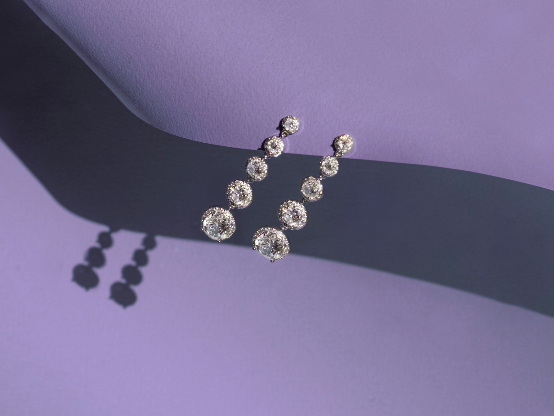 Diamond drop earrings on a sculptural lilac set
